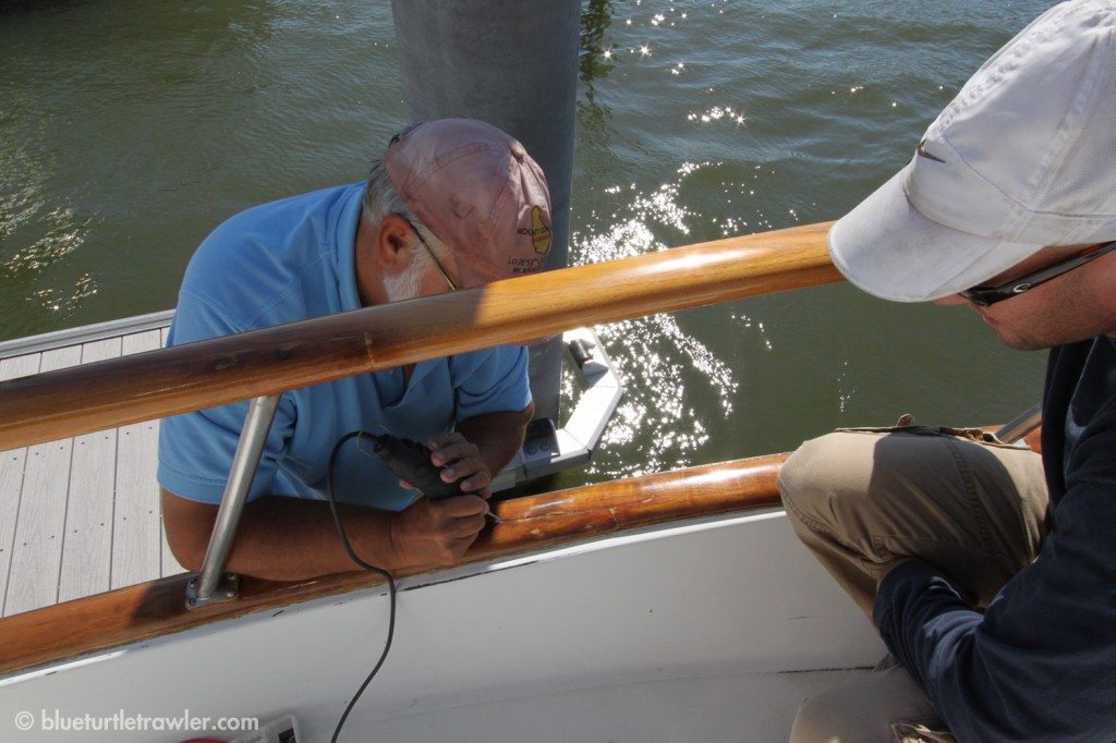 Capt. Tom helps Randy drill out the old Life Caulk