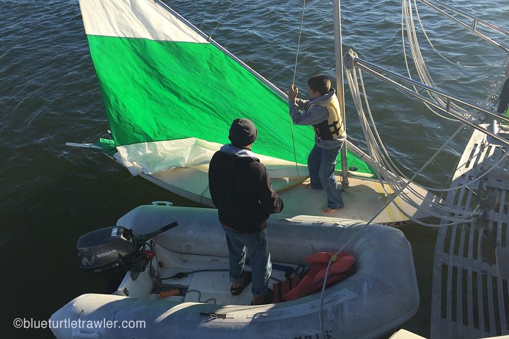 Corey hoists up the sail to take Grandpa for a ride